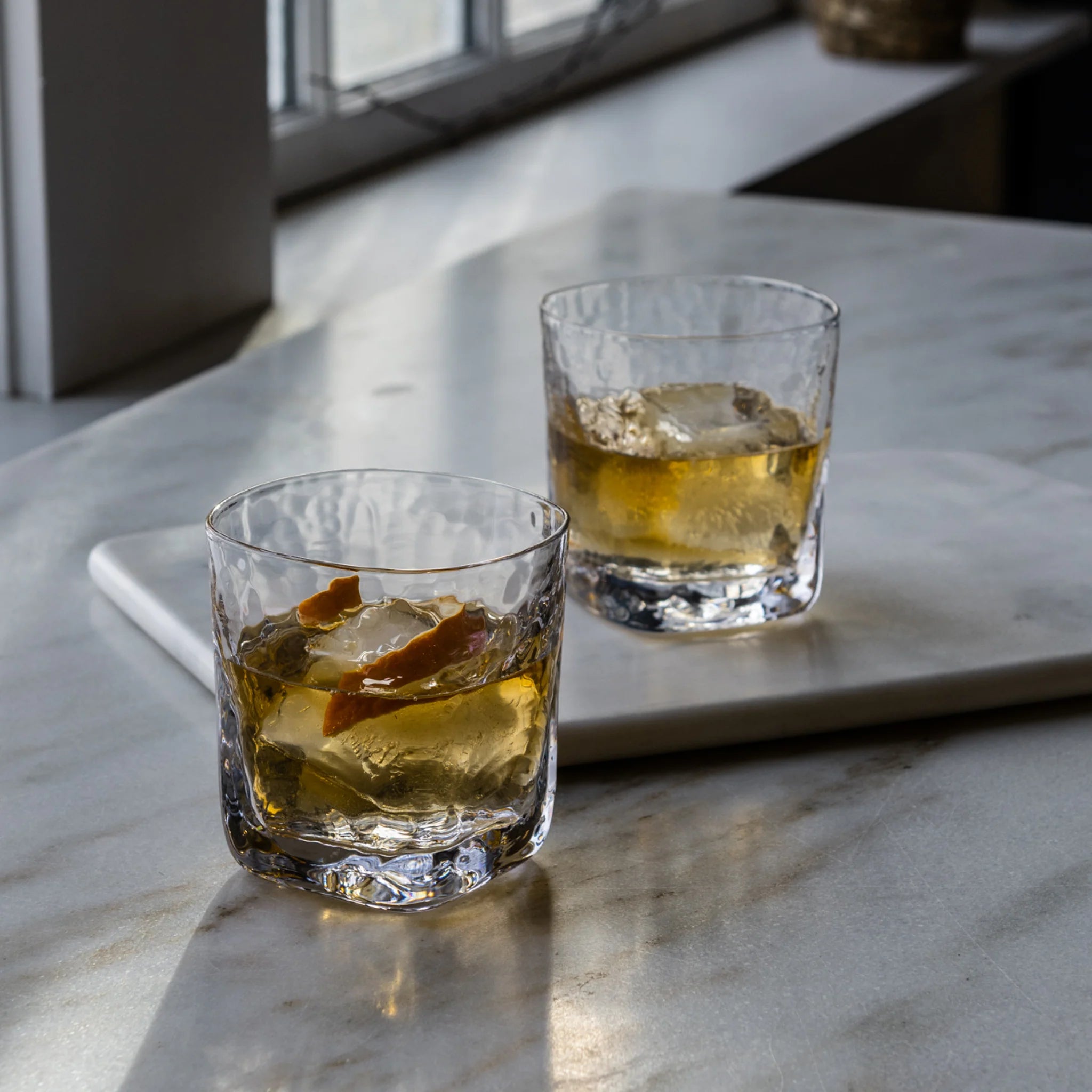 Woodbury Double Old-Fashioned Glass, Set of 2 on a marble kitchen table at Addison West