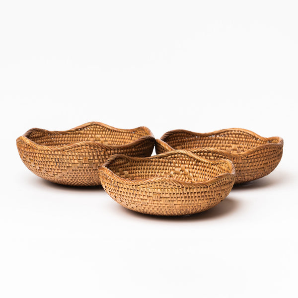 Set of 3 hand woven rattan nesting bowls with wavy lip by bloomingville on a white background