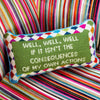 Furbish brand needlepoint pillow with saying 'well, well, well, if it isn't the consequences of my own actions' on a colorful printed fabric chair 