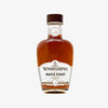 WhistlePig Rye Whiskey Barrel-Aged Maple Syrup bottle on a white background