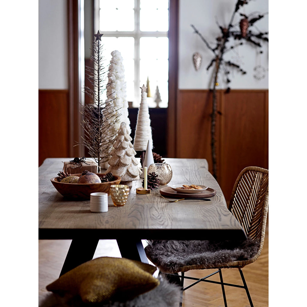 Wood dining table with seasonal holiday display of various types of christmas trees