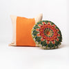 Two bright orange and pink and green pillows on a white background