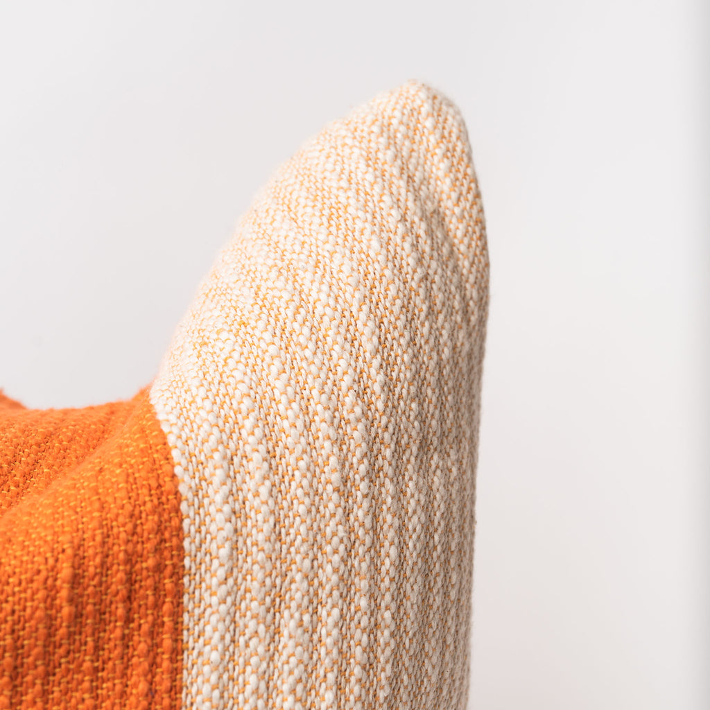 Close up of Cotton pillow with bright and dark orange cotton contrast on a white background