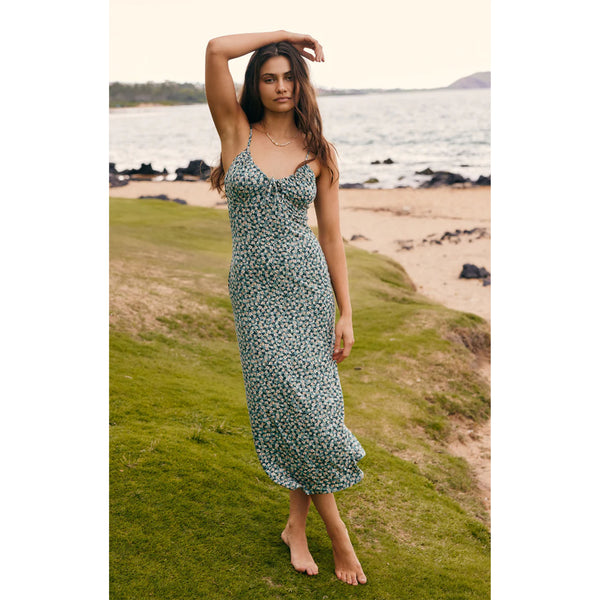 Model wearing Z Supply Melinda Ditsy Floral Midi Dress In Emerald Isle on a beach with ocean in the background