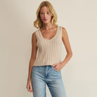 Woman wearing Z Supply Acadia Sweater Tank in Island Coconut on plain background at Addison West.