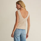 Woman wearing Z Supply Acadia Sweater Tank in Island Coconut on plain background at Addison West.