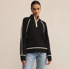 Woman wearing Z Supply Alps Half Zip Sweater in Black against a beige background