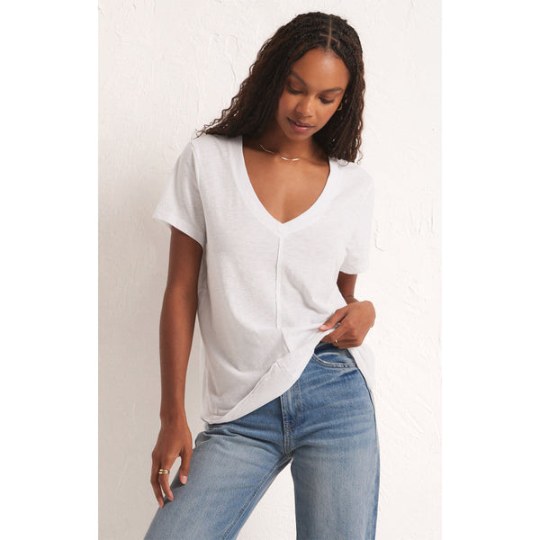 Model wearing Z Supply Asher V-Neck Tee in White with jeans in front of a white background