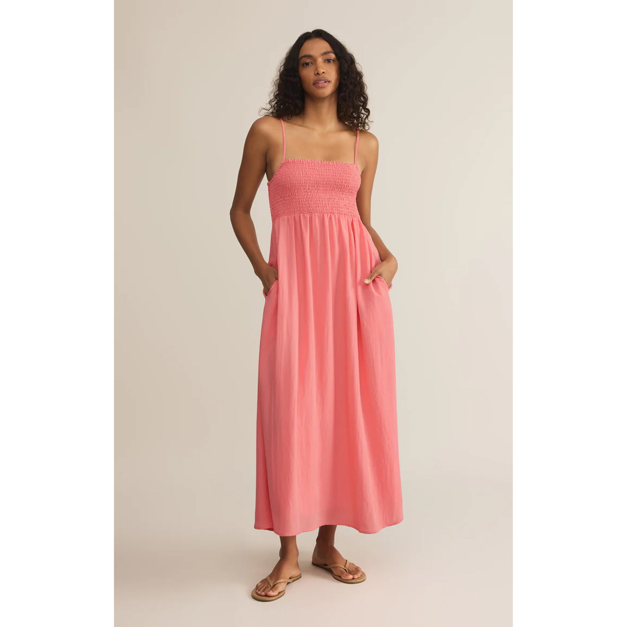 Model wearing Z Supply Beachside Midi Dress in Sunset Pink in front of a neutral backdrop