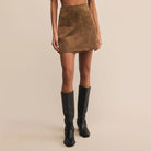 Person Z Supply Ciera Suede Mini Skirt in Coconut and black knee-high boots on a beige background