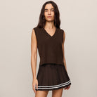 Woman wearing Z Supply Classic Act Sweater Vest in Dark Chocolate on plain background at Addison West.