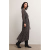 Brunette model wearing Z Supply Della Floral Midi Dress in Black with black boots in front of a white background