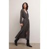Brunette model wearing Z Supply Della Floral Midi Dress in Black with black boots in front of a white background