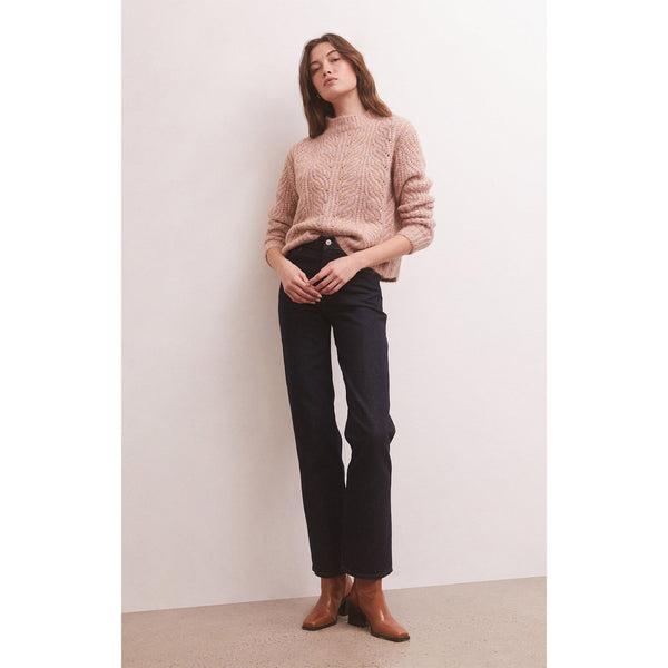 Z Supply Dove Sweater in Shadow Mauve on model with black pants and brown boots in front of a white wall 