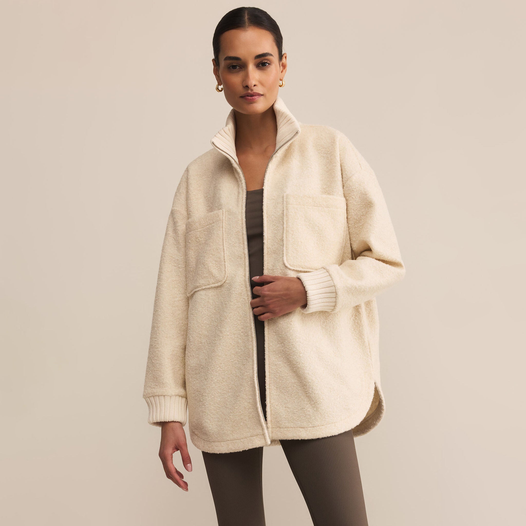 Woman wearing Z Supply Downhill Jacket in Coconut against a beige background