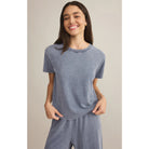 Model wearing Z Supply Go To Denim Tee in Medium Indigo with matching pants in front of a neutral backdrop
