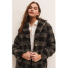 Model wearing black pants and loafers and Z Supply Hastings Sherpa Coat in front of a neutral wall
