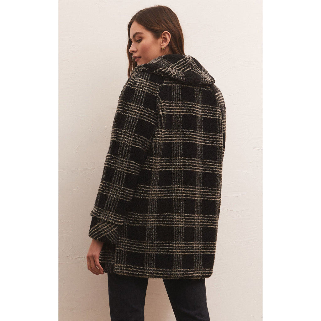 Model wearing black pants and loafers and Z Supply Hastings Sherpa Coat in front of a neutral wall