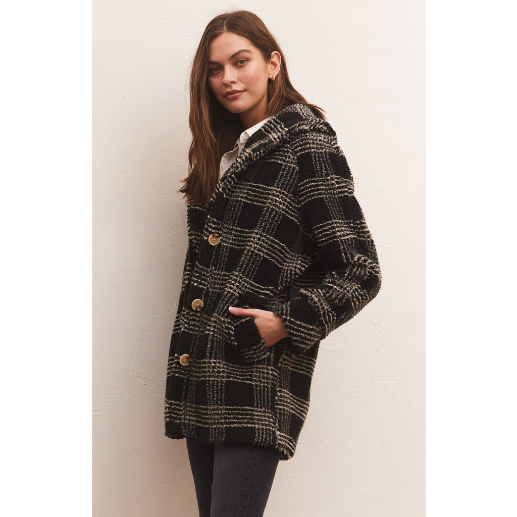 Model wearing black pants and loafers and Z Supply Hastings Sherpa Coat in front of a neutral wall