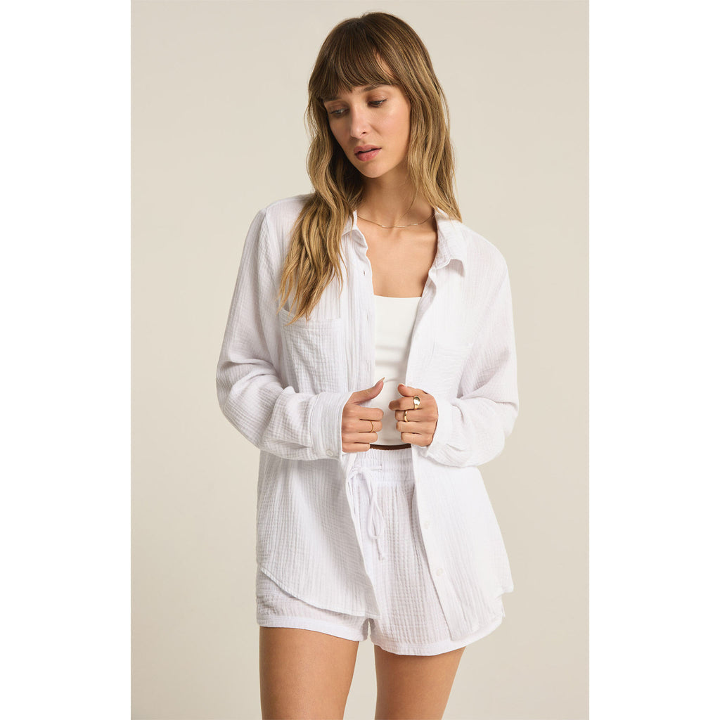 Model wearing Z Supply Kaili Button Up Gauze Top in White with matching shorts