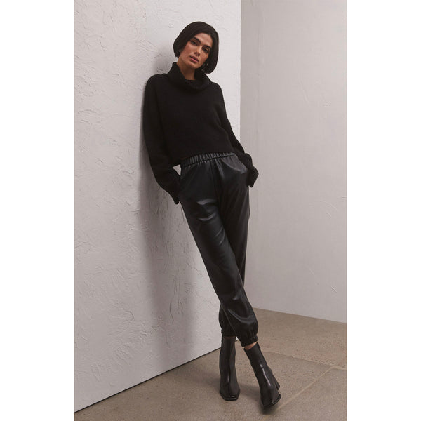 Model wearing black turtleneck and Z Supply Lenora Faux Leather Jogger in Black