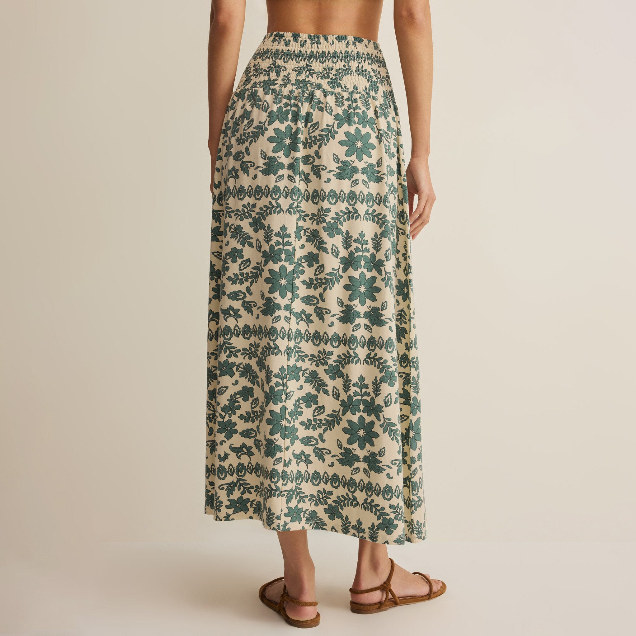 Woman wearing Z Supply Leya Tera Paisley Maxi Skirt in Everglade on plain background at Addison West.