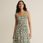 Woman wearing Z Supply Leya Tera Paisley Smocked Top in Everglade on plain background at Addison West.