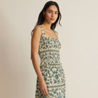 Woman wearing Z Supply Leya Tera Paisley Smocked Top in Everglade on plain background at Addison West.
