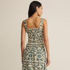 Woman wearing Z Supply Leya Tera Paisley Smocked Top in Everglade on plain background at Addison West.