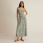 Woman wearing Z Supply Leya Tera Paisley Smocked Top in Everglade on plain background at Addison West.