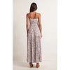 Back view of Model wearing Z Supply Lisbon Floral Maxi Dress in Sandstone in front of a white backdrop 