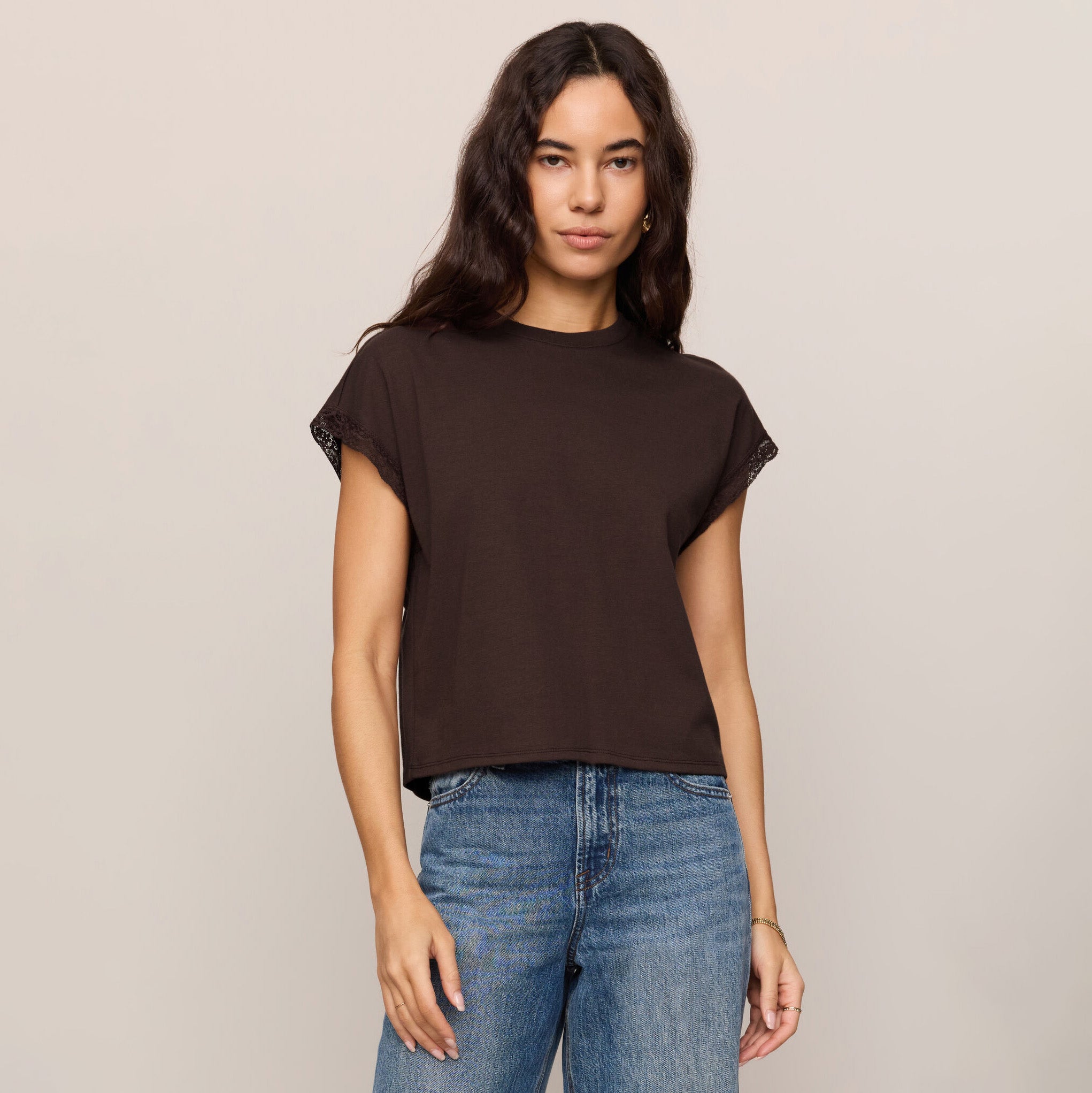 Woman wearing Z Supply Markia Lace Trim Muscle Tee in Dark Chocolate on plain background at Addison West.