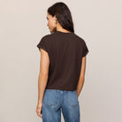 Woman wearing Z Supply Markia Lace Trim Muscle Tee in Dark Chocolate on plain background at Addison West.