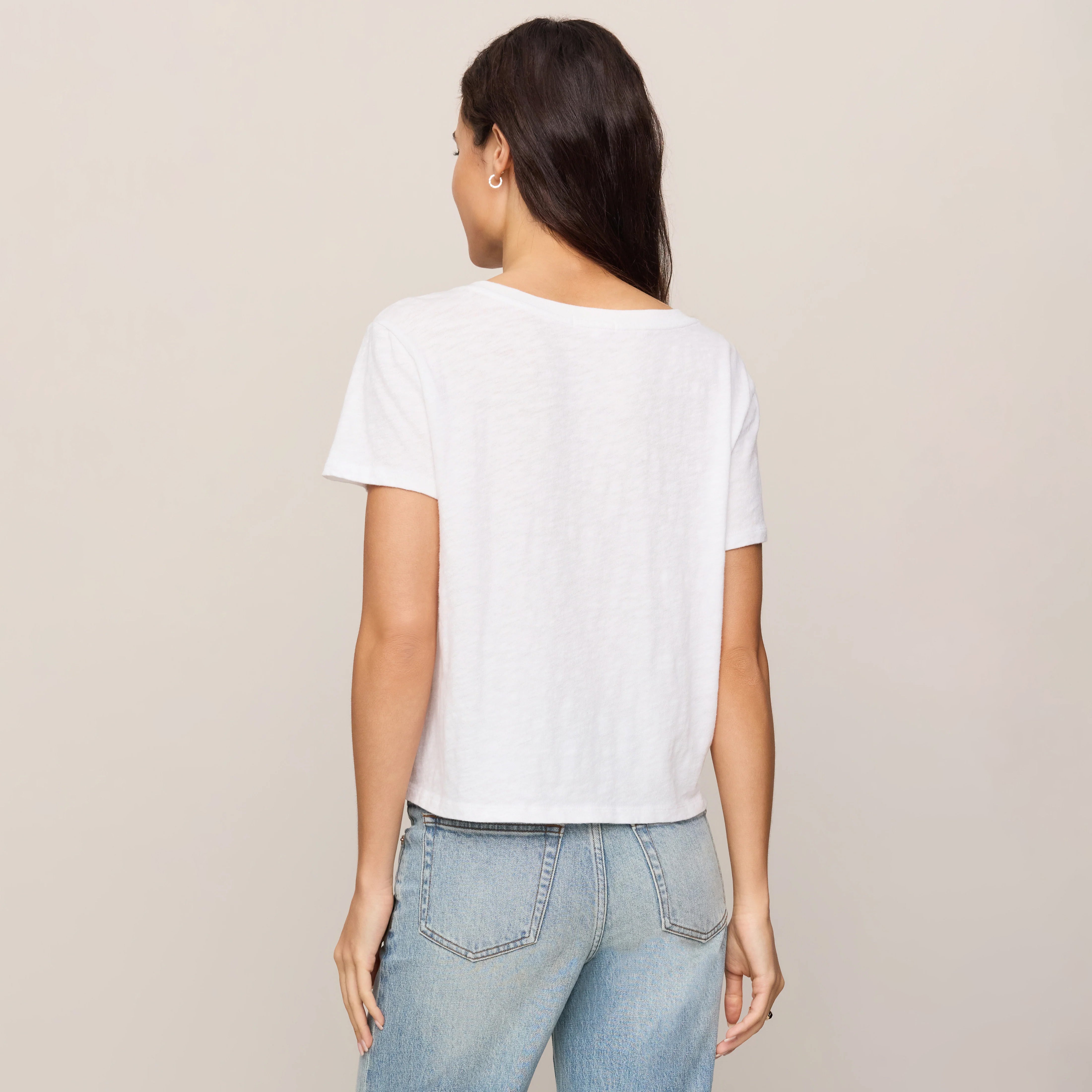 Z Supply Nomad V-Neck Tee in White shown on model on plain background.