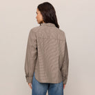 Woman wearing Z Supply On Duty Gingham Button Up in Dark Chocolate on plain background at Addison West.