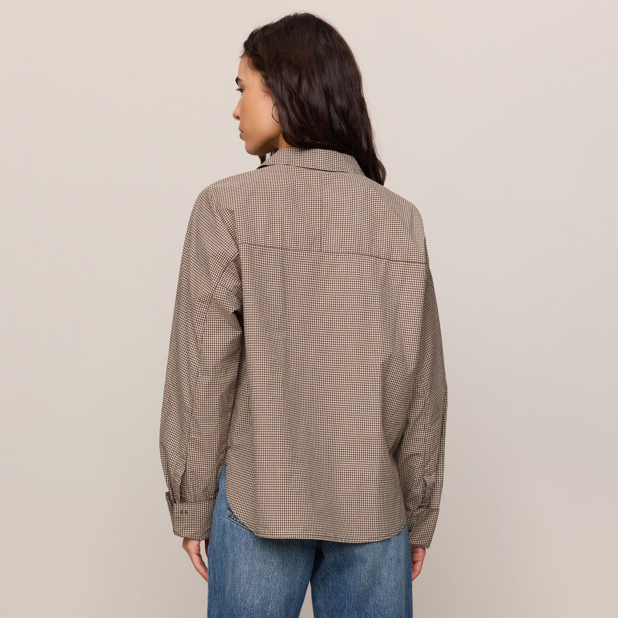 Woman wearing Z Supply On Duty Gingham Button Up in Dark Chocolate on plain background at Addison West.