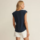 Woman wearing Z Supply Per Diem V-Neck Tank in Eclipse on plain background at Addison West.