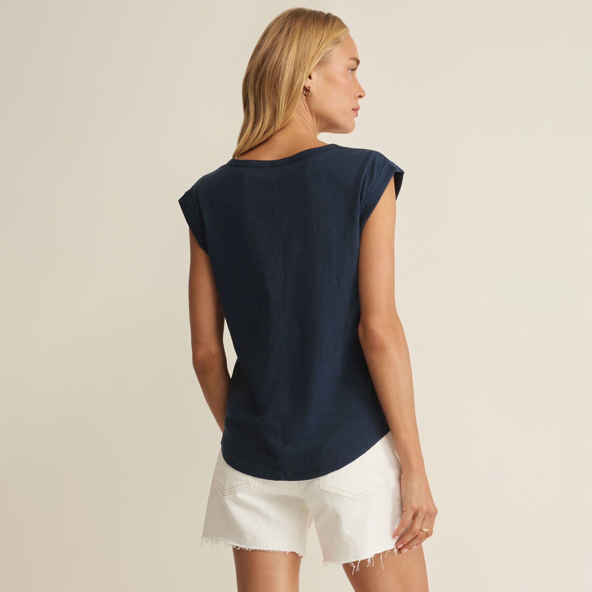 Woman wearing Z Supply Per Diem V-Neck Tank in Eclipse on plain background at Addison West.