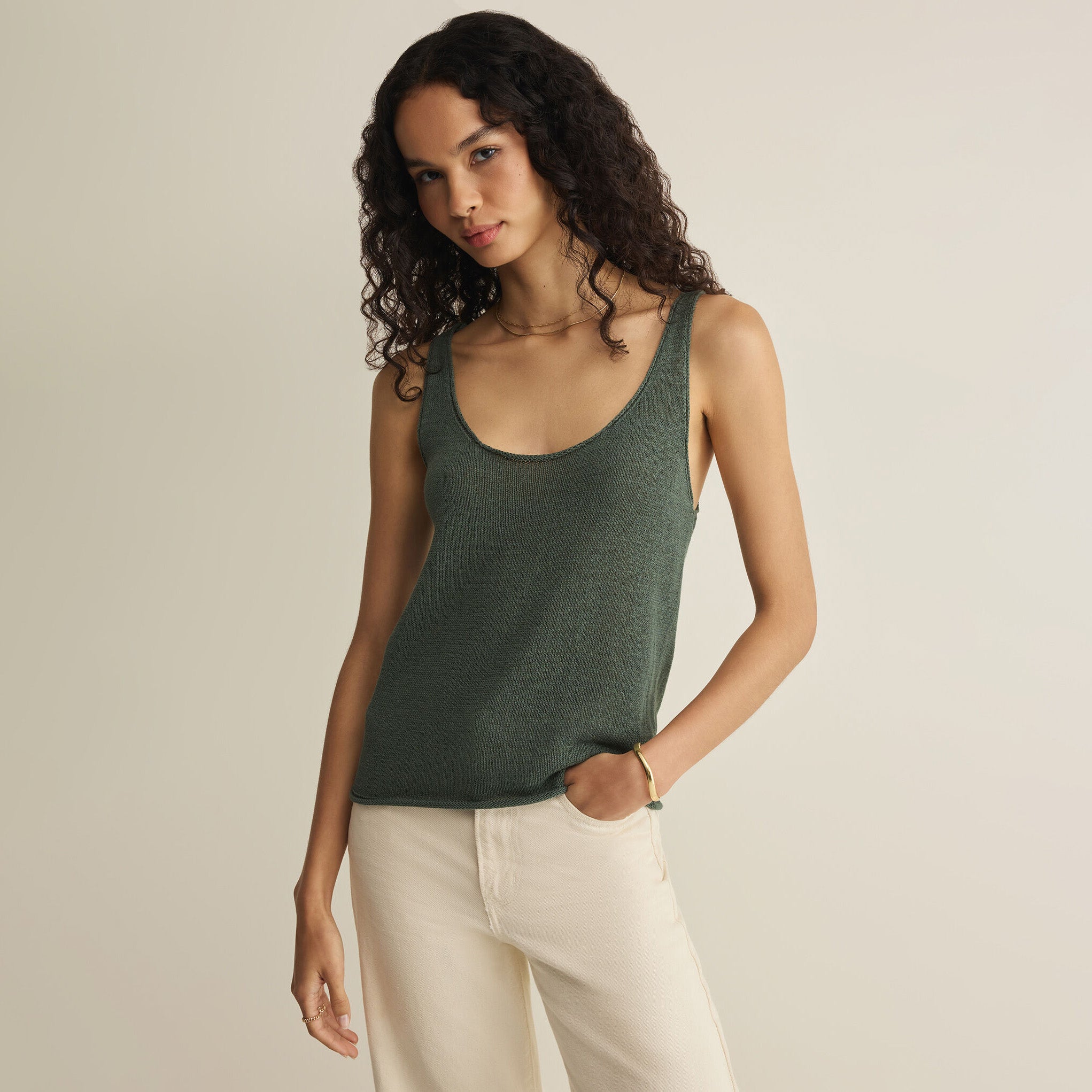Woman wearing Z Supply Perch Sweater Tank in Everglade on plain background at Addison West.