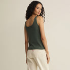 Woman wearing Z Supply Perch Sweater Tank in Everglade on plain background at Addison West.
