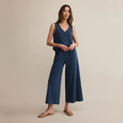 Woman wearing Z Supply Scout Jersey Denim Pant in Indigo on a beige background