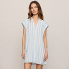 Woman wearing Z Supply Shellbound Striped Dress in Sea Salt on plain background at Addison West.