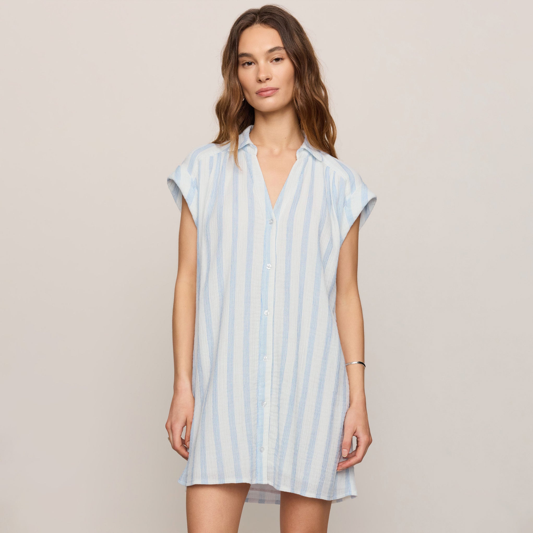 Woman wearing Z Supply Shellbound Striped Dress in Sea Salt on plain background at Addison West.