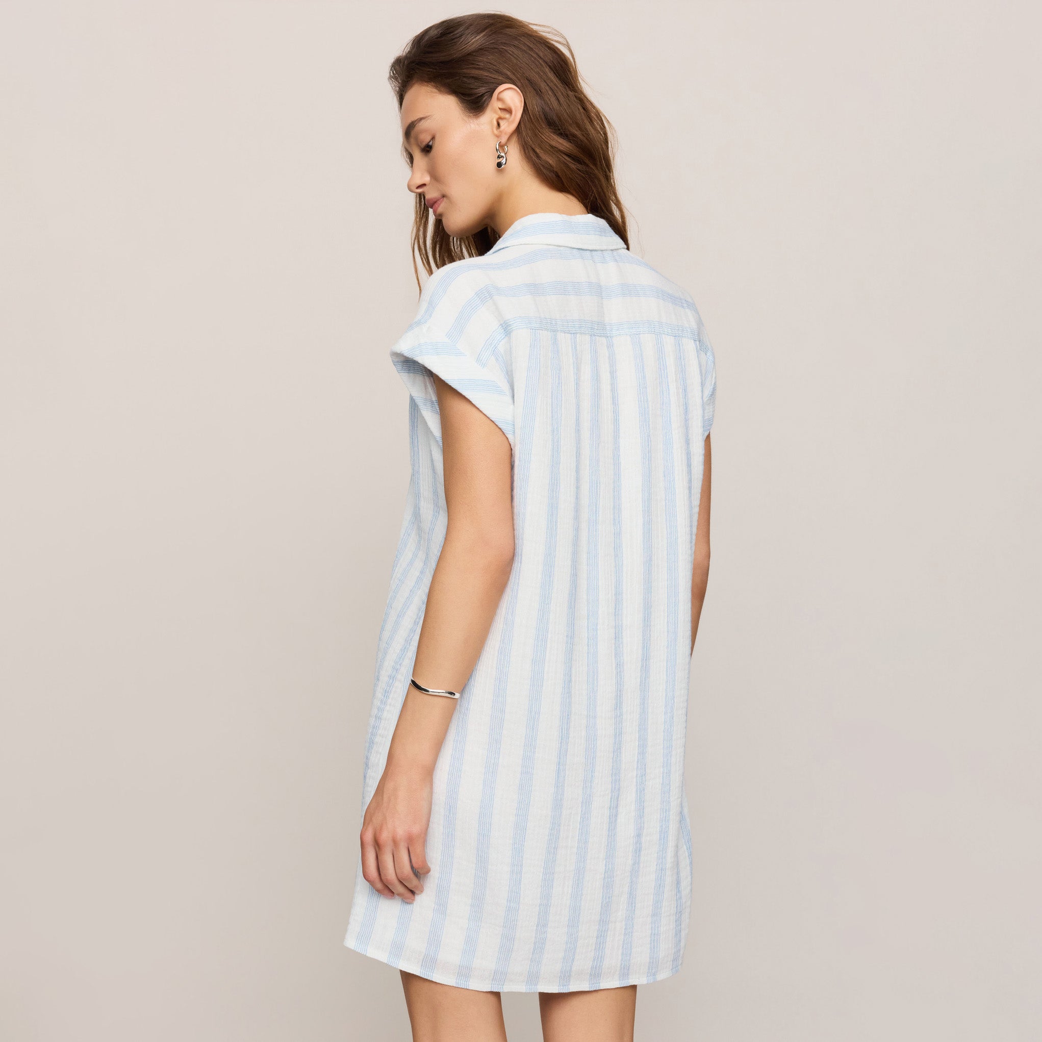 Woman wearing Z Supply Shellbound Striped Dress in Sea Salt on plain background at Addison West.