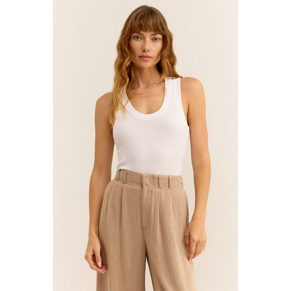 Model wearing Z Supply Sirena Rib Tank in White with beige pleated linen pants