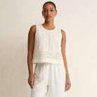 Woman wearing Z Supply Sloane Embroidered Top in White on plain background at Addison West.