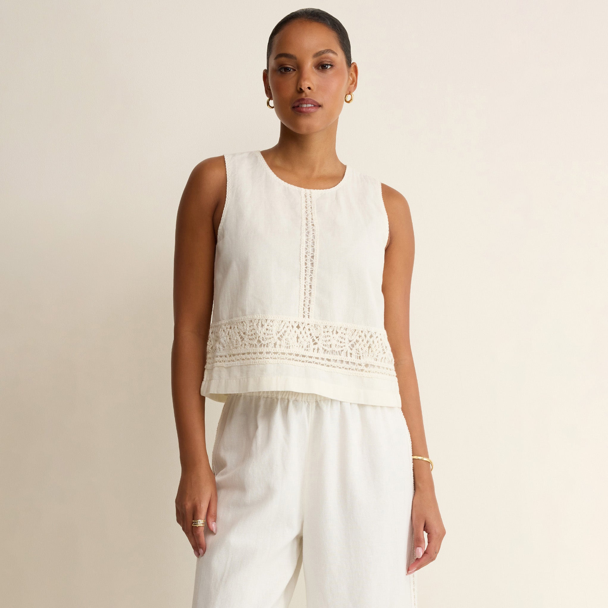 Woman wearing Z Supply Sloane Embroidered Top in White on plain background at Addison West.