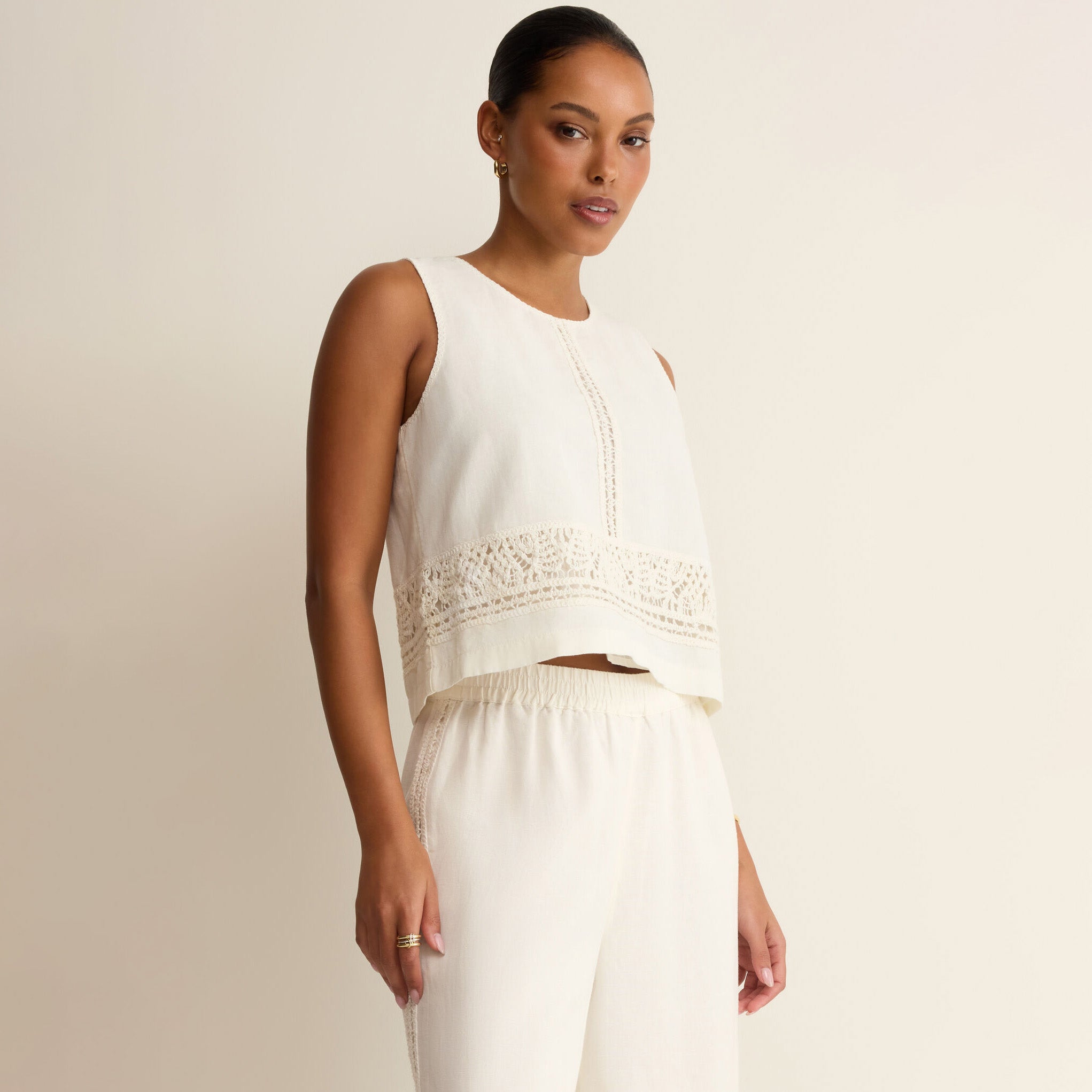Woman wearing Z Supply Sloane Embroidered Top in White on plain background at Addison West.