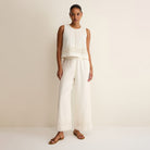 Woman wearing Z Supply Sloane Embroidered Top in White on plain background at Addison West.