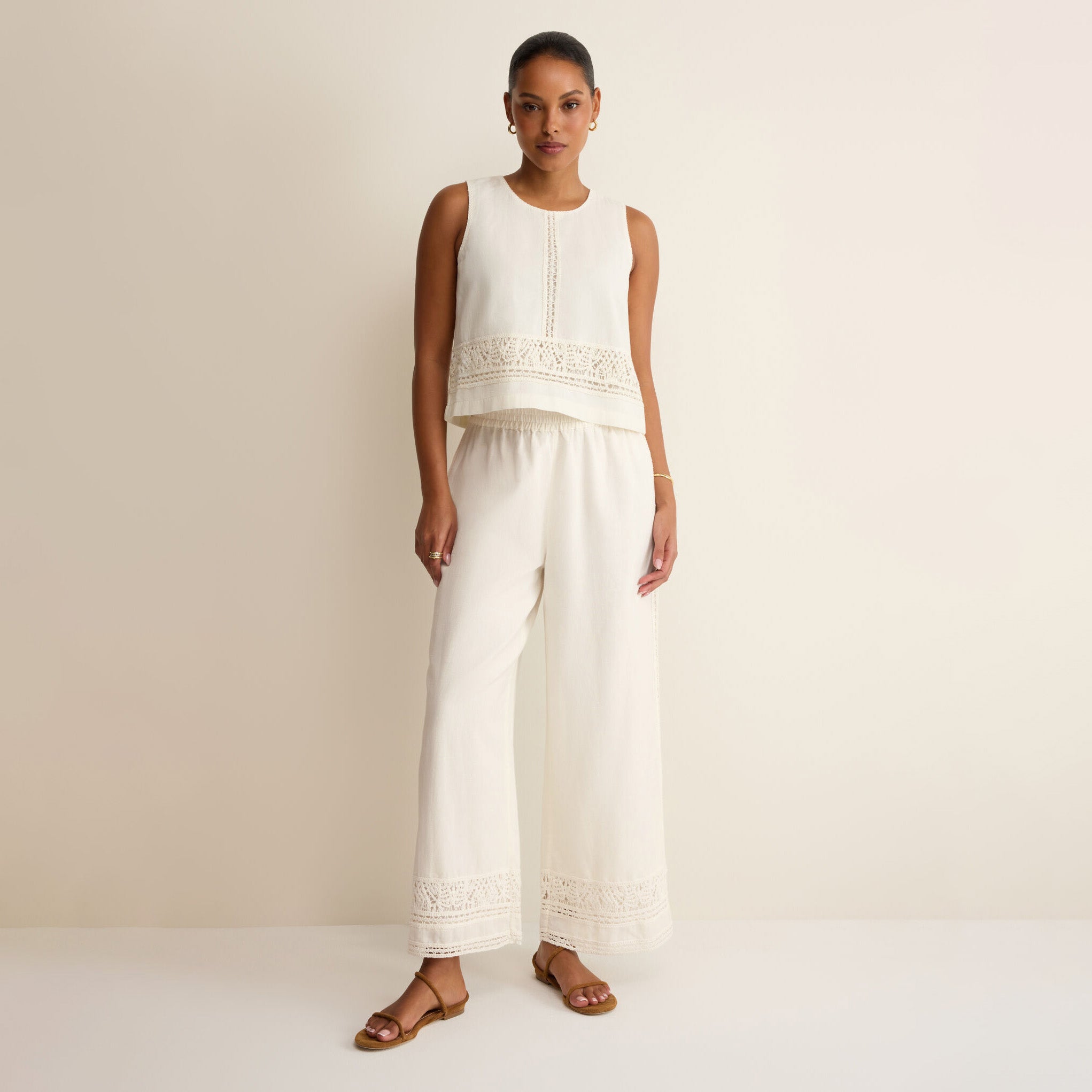 Woman wearing Z Supply Sloane Embroidered Top in White on plain background at Addison West.
